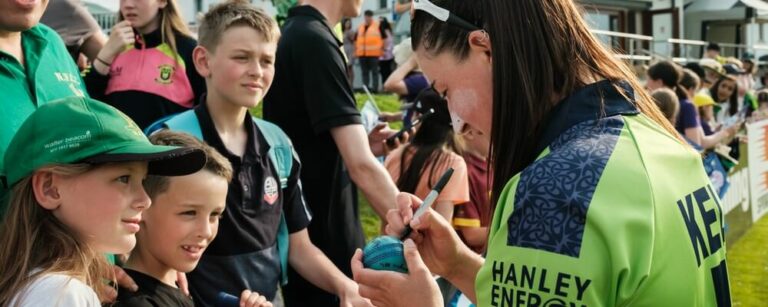 Arlene signing a ball