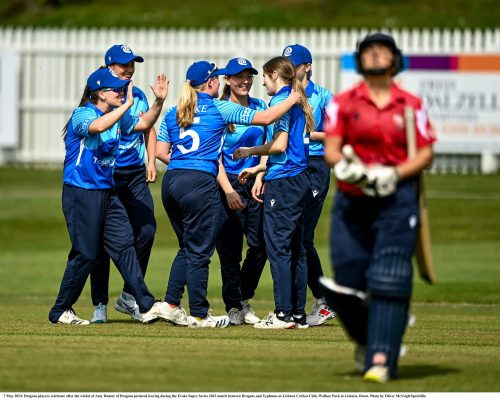7 May 2023; Dragons players celebrate after the wicket of Amy Hunter of Dragons pictured leaving during the Evoke Super Series 2023 match between Dragons and Typhoons at Lisburn Cricket Club, Wallace Park in Lisburn, Down. Photo by Oliver McVeigh/Sportsfile
