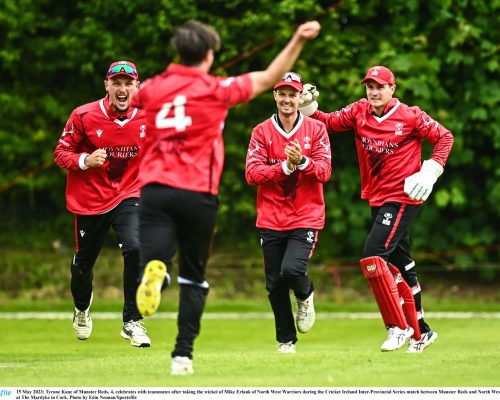 15 May 2023; Tyrone Kane of Munster Reds, 4, celebrates with teammates after taking the wicket of Mike Erlank of North West Warriors during the Cricket Ireland Inter-Provincial Series match between Munster Reds and North West Warriors at The Mardyke in Cork. Photo by Eóin Noonan/Sportsfile