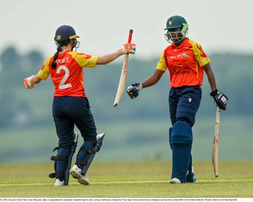 21 May 2023; Scorchers batter Mary-Anne Musonda, right, is congratulated by teammate Annabelle Squires after scoring a half-century during the Evoke Super Series match between Typhoons and Scorchers at Oak Hill Cricket Club in Kilbride, Wicklow. Photo by Seb Daly/Sportsfile